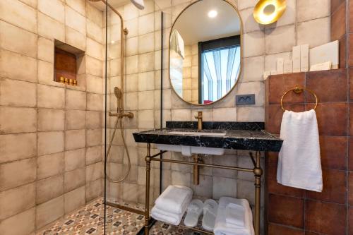 a bathroom with a sink and a mirror at Khai Karaköy in Istanbul