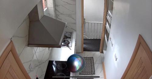 an overhead view of a small kitchen with a stove at New flat, own bathroom, sitting room & large bedroom - Walsall in Bescot