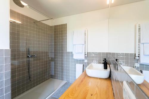 a bathroom with a tub and a sink and a shower at Solar Branco Eco Estate in Ponta Delgada
