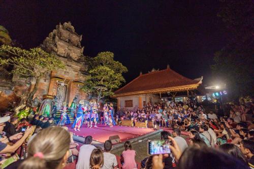 a crowd of people watching a show on a stage at Saren Kauh Ubud Palaceॐ in Ubud
