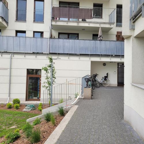 a building with a balcony and a bike on a walkway at Oskar Apartament Centrum PKP in Mińsk Mazowiecki