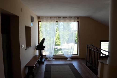 a living room with a large window and a piano at Casa Atenea in Zamora