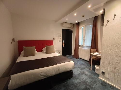 Ένα ή περισσότερα κρεβάτια σε δωμάτιο στο Hotel Aida Marais