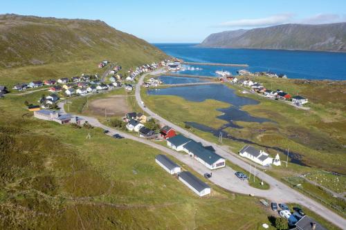 an aerial view of a parking lot next to a body of water at Arctic Lodging North Cape in Skarsvåg