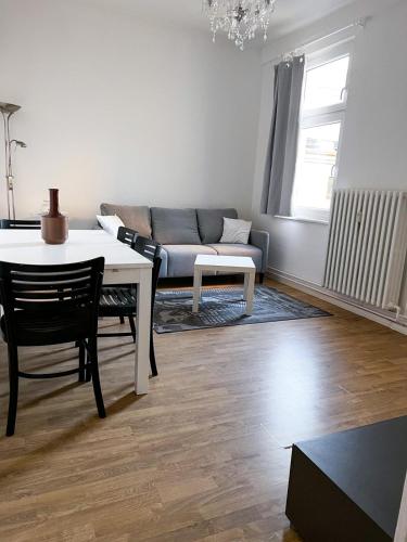 a living room with a table and a couch at Aventura Flat 1 in Bremen