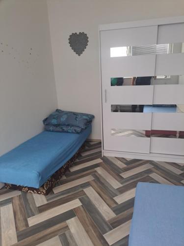 a small room with a bed and a cabinet at Apartmá u Faltýnka in Brněnské Ivanovice