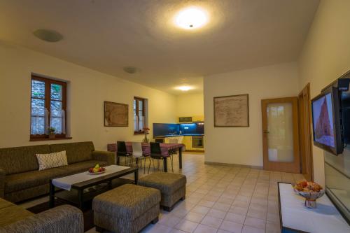 a living room with a couch and a table at Apartmány Weissov Dom in Banská Štiavnica