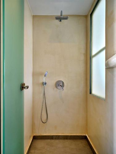a shower in a bathroom with a shower head at Ocean View Paros in Parikia
