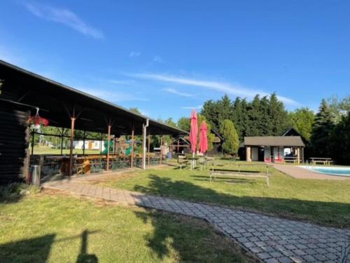 a park with a pavilion and benches and a building at Kemp Josef Dubňany in Dubňany