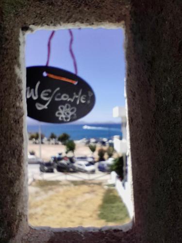 a view of the beach through a hole in a wall at Naxos Crafts' House in Naxos Chora