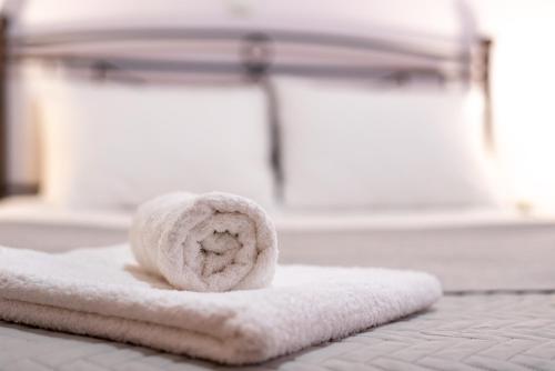 a white towel sitting on top of a bed at Sea and Airport in Artemida
