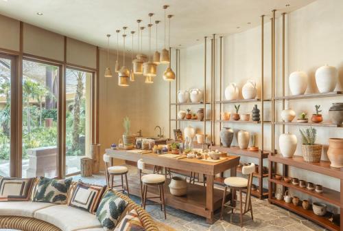 a living room with a table and chairs at Six Senses Southern Dunes, The Red Sea in Khuff