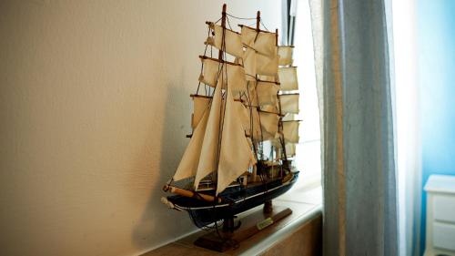 a model ship on a shelf in a room at Florivana Boutique Hotel in San Pietro in Cariano