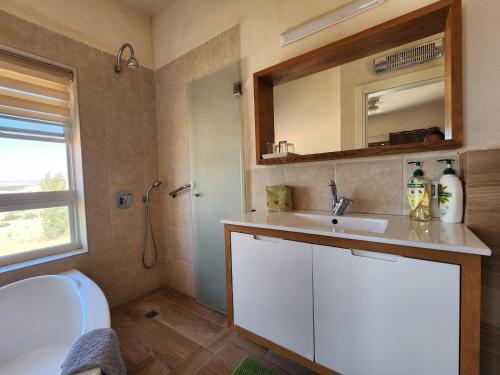 a bathroom with a sink and a toilet and a mirror at מול הכנרת Over looking the Sea of Galilee in Chorazim