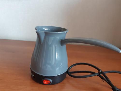 a blue coffee maker sitting on a wooden table at Bună Ziua apartment Tonitza Nic. in Cluj-Napoca
