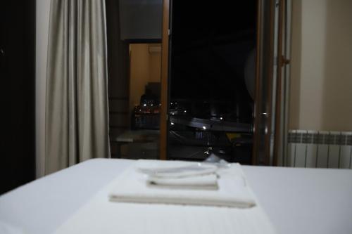 a bedroom with a white bed and a mirror at The K Tbilisi in Tbilisi City