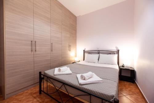 a bedroom with a bed with two towels on it at Sea and Airport in Artemida