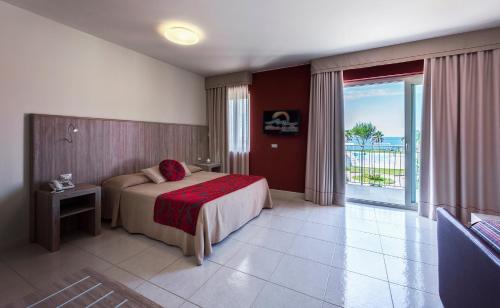 a hotel room with a bed and a balcony at Hotel Valeria Del Mar in Belvedere Marittimo
