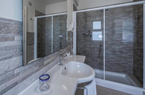 a bathroom with a white sink and a shower at Hotel Valeria Del Mar in Belvedere Marittimo