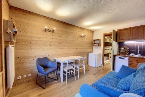 a living room with a blue couch and a table at Rare pearl with incredible views in Les Houches