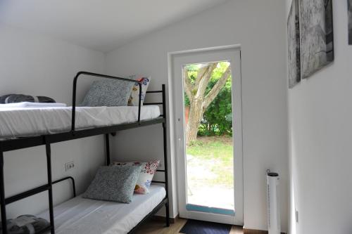 a bedroom with two bunk beds and a doorway at Cozy little hideaway in Balatonfüred