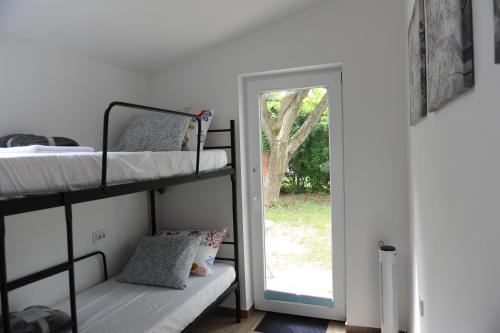 a bedroom with two bunk beds and a doorway at Cozy little hideaway in Balatonfüred