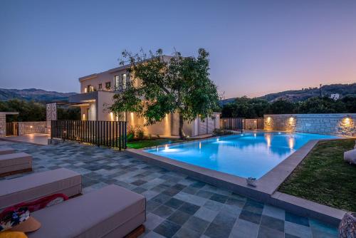 a swimming pool in the backyard of a house at Alyona Villas - Villa Lona in Ayiá