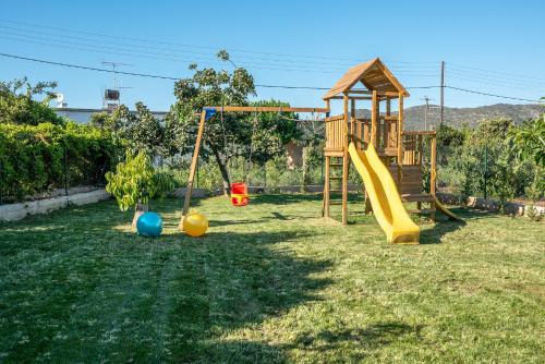 a yard with a playground with a slide and a play structure at Alyona Villas - Villa Lona in Ayiá