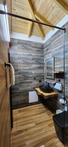 a bathroom with a glass shower and a sink at Vila 369 Dhermi in Dhërmi