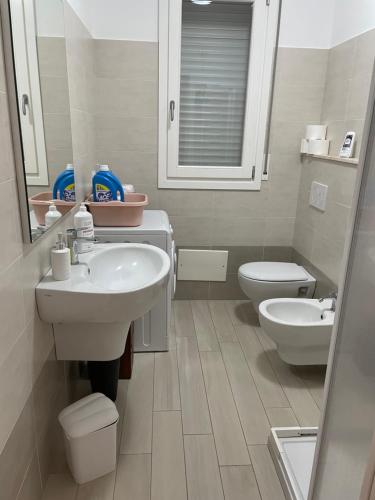 a bathroom with a sink and a toilet and a mirror at Cravellet 67 in Alghero