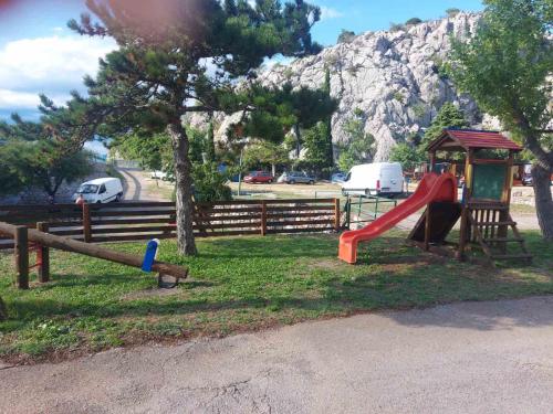 a park with a playground with a slide at Mobile Home Marta in Senj