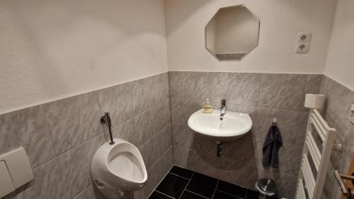 a bathroom with a toilet and a sink at AMW Ferienwohnungen in Legau