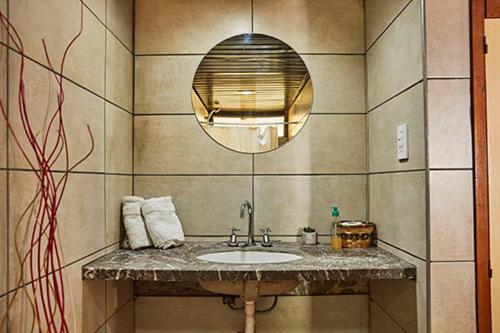 a bathroom with a sink and a mirror at Hostal de Los Andes in Rodeo de la Cruz