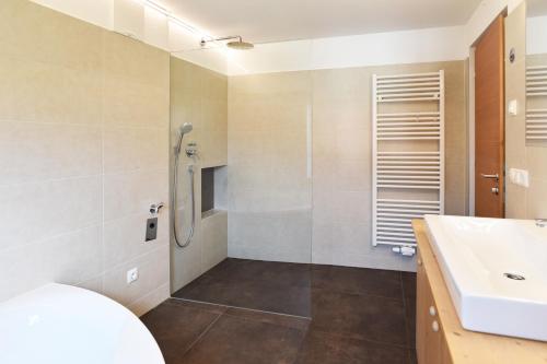 a bathroom with a sink and a shower at Salina number 1 in Glorenza