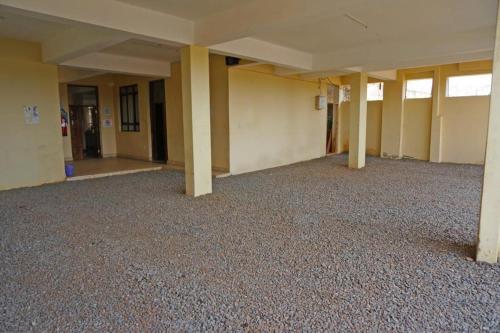 an empty room with columns in an empty building at Mipeja Hotel in Busia