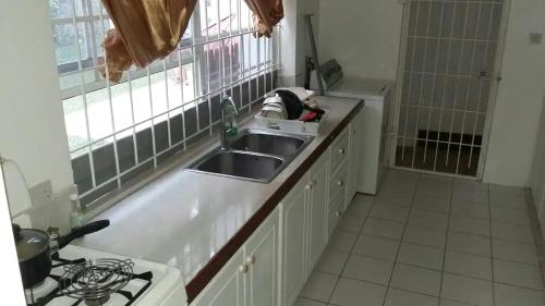 a kitchen with a sink and a counter top at Lynn's Place in Castries