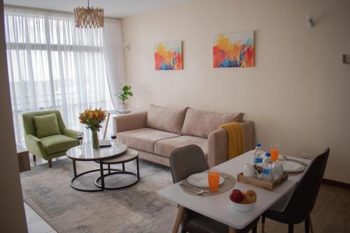 a living room with a couch and a table at Egoli Premiere Serviced Apartments by Nest & Nomad in Nairobi