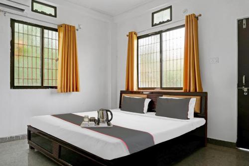 Ένα ή περισσότερα κρεβάτια σε δωμάτιο στο Flagship Arman Residency & Guest House