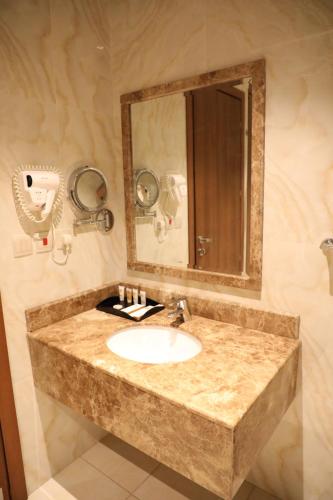 a bathroom with a sink and a mirror at Best Level Hotel in Jeddah