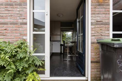 an open door leading to a kitchen and a house at Sky Villa in Bergschenhoek
