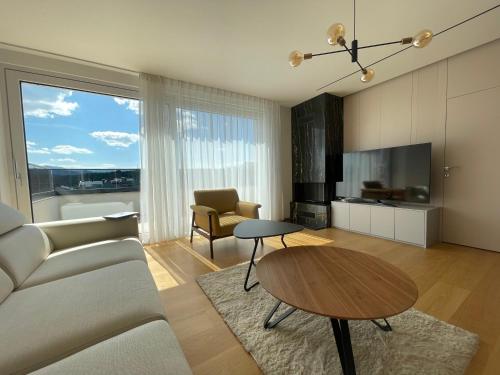 a living room with a couch and a table at Gega Apartments in Gjakove