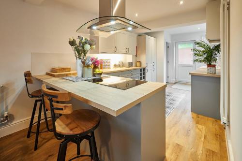 a kitchen with a large island with a counter top at Host & Stay - The View at Orchard View in Hognaston