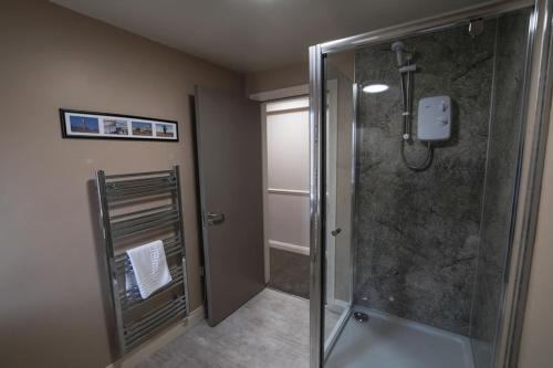 a shower in a bathroom with a glass shower stall at Morecambe Rooms in Morecambe