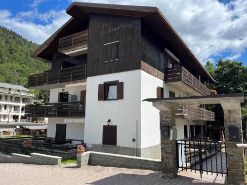 a building with a gambrel roof and a balcony at Giava’s Mountain Place Aprica in Aprica