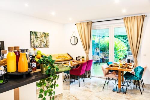 a kitchen and dining room with a table and chairs at Hotel Fürst Garden in Dortmund