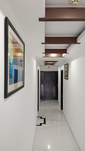 a hallway in a building with a picture on the wall at VENUS.HOTEL in Mohali