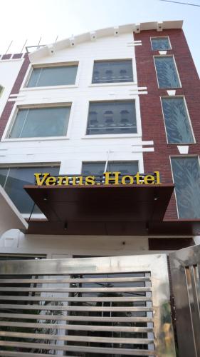 a hotel sign on the side of a building at VENUS.HOTEL in Mohali
