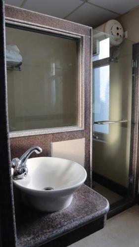 a white sink in a bathroom with a mirror at VENUS.HOTEL in Mohali
