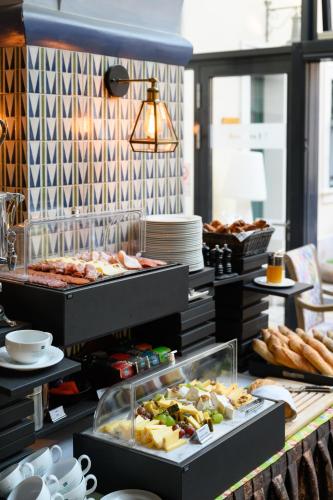 a buffet with many different types of food on display at Maison Bistro & Hotel in Budapest