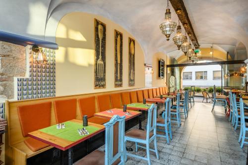 a row of tables and chairs in a restaurant at Maison Bistro & Hotel in Budapest